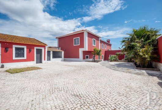 An elegant villa with a view of the River Tagus and the city of Lisbon, nestled in the Portuguese town of Trafaria