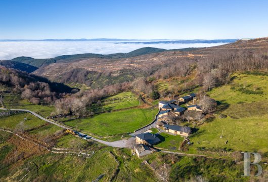 In Galicia, in the Ribeira Sacra, a group of traditional stone buildings with panoramic views, on land overlooking the valley.