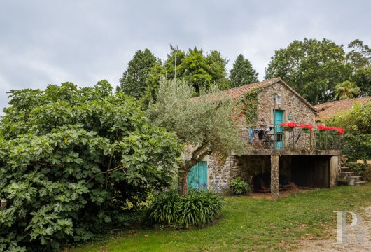 In Galicia, a historic 15th-century presbytery, its Albariño vineyard in production and its tourist outbuilding ...
