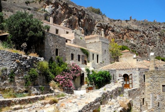 In the Byzantine citadel of Monemvasia, a group of three restored stone houses with panoramic terraces overlooking ...