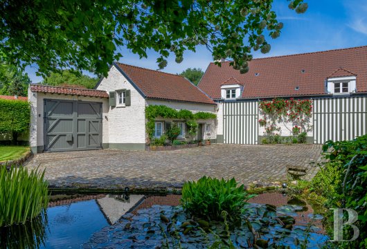 On the outskirts of Brussels, in the historic Waterloo area, a 19th century Flemish farmhouse and its caretaker's ...
