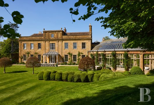 In Somerset, an 1803 Regency residence in Ham stone, with its curved glass roof and structured gardens