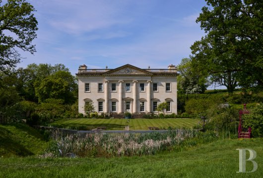 At the gateway to the Cotswolds, in Wotton-under-Edge, a Georgian-style mansion and its annexes, built in carved ...
