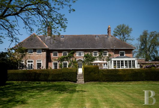 In the Piddle Valley, between Dorchester and the Dorset Hills, a 1790 Georgian farmhouse, its formal terraced garden ...