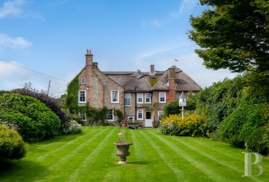 In the hamlet of Benville, in the heart of rural Dorset, a listed 18th-century Georgian house with thatched roof ...