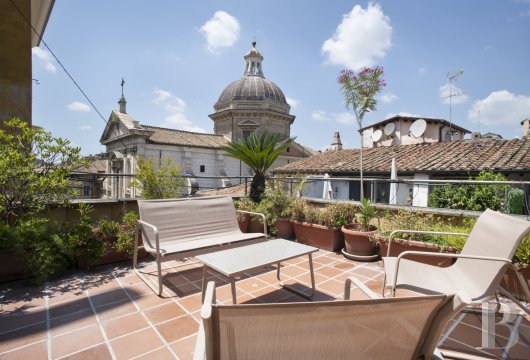 In Rome, a sculptor's studio converted into a luxury flat with a terrace overlooking the rooftops and domes.