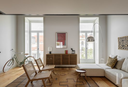 At Largo do Intendente, a contemporary duplex designed by Ana Costa with a balcony and mezzanine