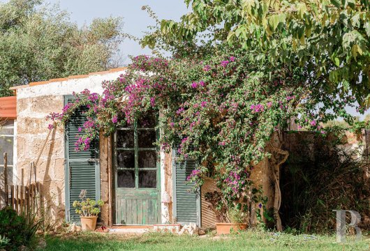 In the countryside near Ciutadella, Menorca, a 7.5-hectare property with a main building divided into two residences ...