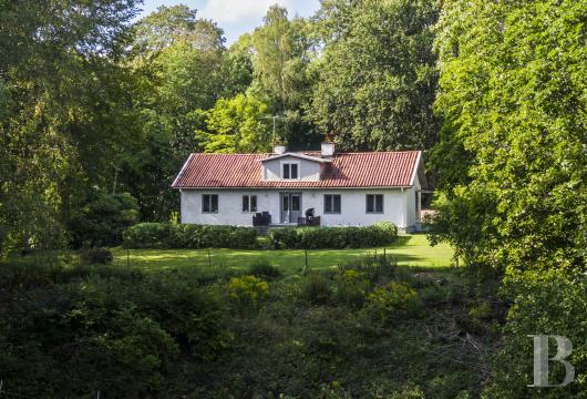 In Sweden, on the shores of Lake Mälaren, an old house with stables and a view of the lake