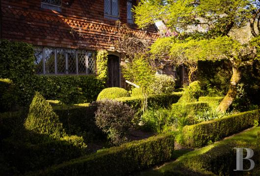 In Staplefield, West Sussex, a Tudor mansion dating from 1481 that was remodeled in the Georgian style, set on ...