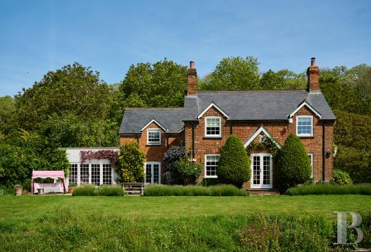 In the Chiltern Hills, Buckinghamshire, a former 19th-century forester’s cottage, renovated on a plot of around ...