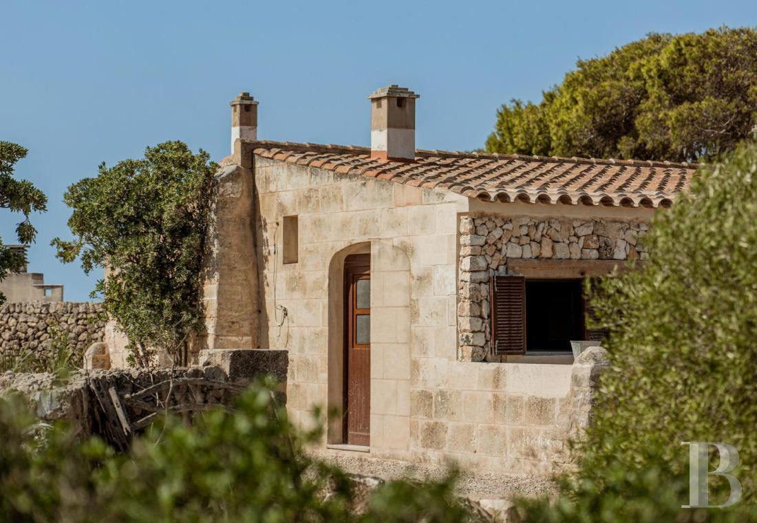 Just a few minutes from Ciutadella,<br/>a rustic Menorcan home with two separate units and a view of the sea