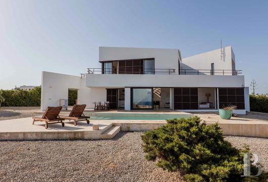 In Cala Morell, an architect-designed villa of approximately 272 m² on a lot of about 927 m², perched on a cliff ...